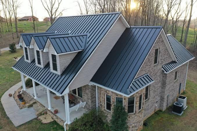 Finished dark standing-seam metal roof on a home with multiple roof planes