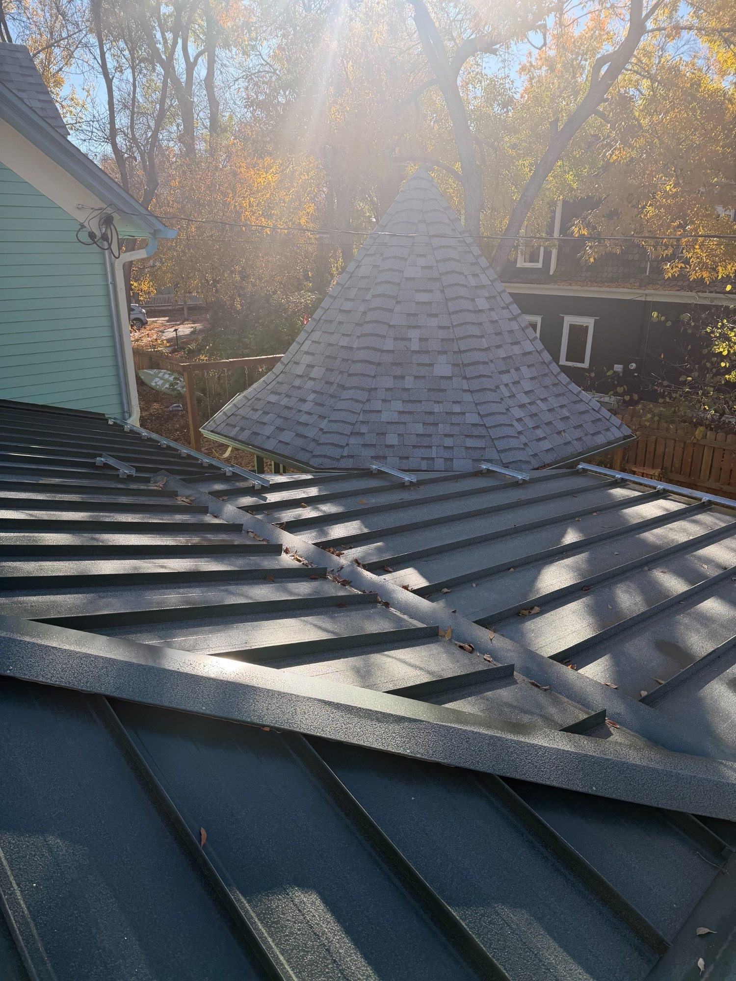 Drennen standing-seam metal roof with complex intersecting roof planes