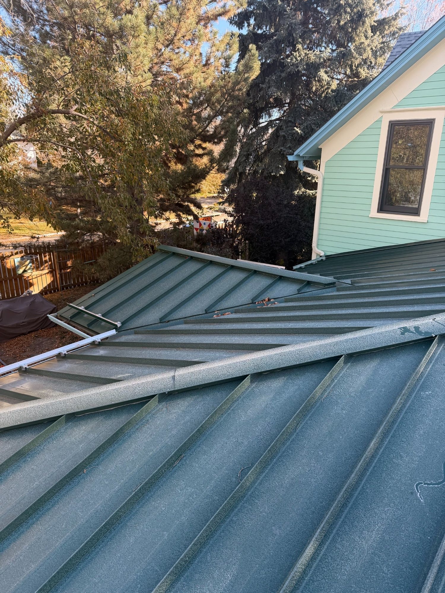 Standing-seam metal roof valley and intersecting roof planes