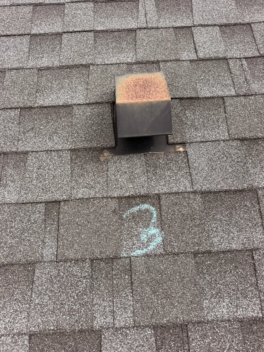 Rust visible on a roof exhaust hood in a Drennen inspection photograph.
